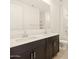 Bathroom showcasing dual sinks, dark wood cabinetry and sleek fixtures at 17426 W Eva St, Waddell, AZ 85355