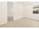 Open bedroom with light wood flooring and a bright window at 17426 W Eva St, Waddell, AZ 85355