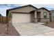 Attractive single-story home with a two-car garage and a concrete driveway at 17426 W Eva St, Waddell, AZ 85355