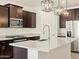 Modern kitchen with granite countertops, stainless steel appliances, and stylish pendant lighting at 17426 W Eva St, Waddell, AZ 85355