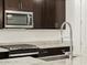 Close-up showcasing kitchen details: granite countertops, stainless steel appliances, and stylish fixtures at 17426 W Eva St, Waddell, AZ 85355