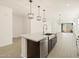 Modern kitchen with granite countertops, stainless steel appliances, and an open floorplan at 17426 W Eva St, Waddell, AZ 85355