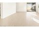 Bright living room with tile floors, flowing to patio with sleek sliding glass door and white walls at 17426 W Eva St, Waddell, AZ 85355