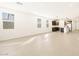 Bright, open living room with tile floors flows into a modern kitchen, illuminated by natural light at 17426 W Eva St, Waddell, AZ 85355