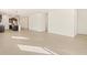 Spacious living room with tile floors, seamlessly connecting to the modern kitchen and dining areas at 17426 W Eva St, Waddell, AZ 85355