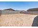 Empty backyard with block wall ready for your custom desert landscape at 17434 W Eva St, Waddell, AZ 85355