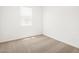 A bright bedroom with large window and neutral carpet at 17434 W Eva St, Waddell, AZ 85355