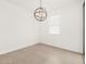 Open dining area featuring modern light fixture and window at 17434 W Eva St, Waddell, AZ 85355