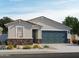 Charming single-story home with a stone accent wall and two-car garage at 17434 W Eva St, Waddell, AZ 85355