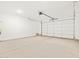 Spacious two car garage with concrete flooring and white walls at 17434 W Eva St, Waddell, AZ 85355