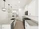 Modern kitchen with stainless steel appliances, granite countertops and spacious island at 17434 W Eva St, Waddell, AZ 85355