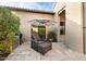 Cozy outdoor patio featuring comfortable seating, an umbrella, and a built-in grill for entertaining guests at 18650 N Thompson Peak Pkwy # 1028, Scottsdale, AZ 85255