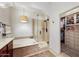 Bright bathroom with a soaking tub, walk-in shower, and spacious walk-in closet with custom shelving at 18650 N Thompson Peak Pkwy # 1028, Scottsdale, AZ 85255