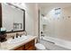 Bright bathroom with a stylish vanity, decorative mirror, and a shower-tub combo with glass partition at 18650 N Thompson Peak Pkwy # 1028, Scottsdale, AZ 85255