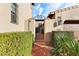 Charming gated entrance with lush hedges, brick pathway, and access to a beautiful home at 18650 N Thompson Peak Pkwy # 1028, Scottsdale, AZ 85255