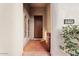 Welcoming front entrance with a wooden door, decorative accents, and a well-manicured landscape at 18650 N Thompson Peak Pkwy # 1028, Scottsdale, AZ 85255
