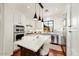 Well-lit kitchen featuring white cabinets, stainless steel appliances, a kitchen island, and granite countertops at 18650 N Thompson Peak Pkwy # 1028, Scottsdale, AZ 85255