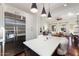 Bright kitchen island with seating with stainless steel appliances and open view to living and dining areas at 18650 N Thompson Peak Pkwy # 1028, Scottsdale, AZ 85255