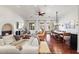 Bright living room with hardwood floors, fireplace, dining table, and stylish neutral décor and furniture at 18650 N Thompson Peak Pkwy # 1028, Scottsdale, AZ 85255