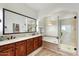 Bright main bathroom features a double vanity, a soaking tub, and a separate shower with glass door at 18650 N Thompson Peak Pkwy # 1028, Scottsdale, AZ 85255