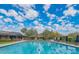 Community pool with lap lanes and ample seating under a sunny sky at 18650 N Thompson Peak Pkwy # 1028, Scottsdale, AZ 85255