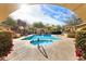 Resort-style pool with a jacuzzi, surrounded by desert landscape and blue skies at 18650 N Thompson Peak Pkwy # 1028, Scottsdale, AZ 85255