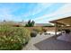 Landscaped backyard with gravel, patio and neighboring house in the background at 18859 N 88Th Dr, Peoria, AZ 85382