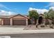 Charming single-story home featuring a three-car garage and desert landscaping at 2033 E Tecoma Rd, Phoenix, AZ 85048