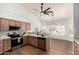 Open kitchen showcasing stainless steel appliances, wood cabinets, and a view into dining area at 2033 E Tecoma Rd, Phoenix, AZ 85048