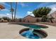 Lush backyard paradise featuring a pool, spa, BBQ, and desert landscaping for private outdoor living at 2033 E Tecoma Rd, Phoenix, AZ 85048