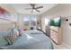 Rest easy in this spacious main bedroom featuring soft natural light, a ceiling fan, and neutral colors at 20921 E Carriage Way, Queen Creek, AZ 85142