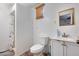 Cozy bathroom featuring a shower, toilet, vanity, and wood window shade at 211 4Th W Ave, Buckeye, AZ 85326