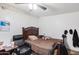 Bedroom featuring ceiling fan, dark wood furnishings, and window with blind at 211 4Th W Ave, Buckeye, AZ 85326