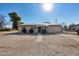 Charming home with solar panels, desert landscaping, and a walkway leading to the front door at 211 4Th W Ave, Buckeye, AZ 85326