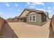 Home's backyard with covered patio and block fence at 23161 E Mockingbird Dr, Queen Creek, AZ 85142