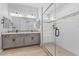 Modern bathroom featuring a glass shower, double vanity, and tile accents at 23161 E Mockingbird Dr, Queen Creek, AZ 85142