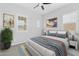 Tastefully decorated bedroom featuring a large bed, decorative pillows, art and a window with shutters at 23161 E Mockingbird Dr, Queen Creek, AZ 85142