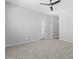 Empty bedroom features plush carpet, ceiling fan, and access to backyard at 23161 E Mockingbird Dr, Queen Creek, AZ 85142