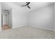 Neutral bedroom with carpeting, ceiling fan, and hallway to the left at 23161 E Mockingbird Dr, Queen Creek, AZ 85142