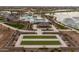 Aerial view of a community pool and recreation area with bocce ball, a pool, and outdoor seating at 23161 E Mockingbird Dr, Queen Creek, AZ 85142