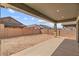 Rear view of home's covered patio and backyard at 23161 E Mockingbird Dr, Queen Creek, AZ 85142