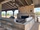 Cozy outdoor stone fireplace with comfortable seating, perfect for relaxation and entertainment at 23161 E Mockingbird Dr, Queen Creek, AZ 85142
