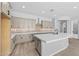 Spacious kitchen with gray cabinets, quartz countertops, and stainless steel appliances at 23161 E Mockingbird Dr, Queen Creek, AZ 85142