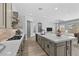 Well-lit kitchen has an expansive island and view to the open living area at 23161 E Mockingbird Dr, Queen Creek, AZ 85142