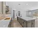 Spacious kitchen featuring an oversized island, designer cabinets, and stainless steel sink at 23161 E Mockingbird Dr, Queen Creek, AZ 85142