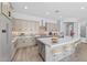 Beautiful open kitchen with quartz island, pendant lighting, and stainless steel refrigerator at 23161 E Mockingbird Dr, Queen Creek, AZ 85142