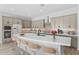 Stylish kitchen with ample counter seating, white countertops, and stainless steel appliances at 23161 E Mockingbird Dr, Queen Creek, AZ 85142