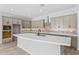 Beautiful kitchen boasts a large center island, quartz countertops, and stainless steel appliances at 23161 E Mockingbird Dr, Queen Creek, AZ 85142