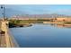 Scenic lake view with manicured landscaping and distant mountain backdrop at 23161 E Mockingbird Dr, Queen Creek, AZ 85142