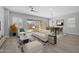 Cozy living and dining area showcasing modern decor, wood floors, and sliding glass doors to the outdoor space at 23161 E Mockingbird Dr, Queen Creek, AZ 85142